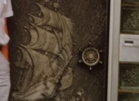 Haustür mit Segelschiffrelief aus Metall